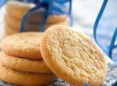 three cookies are stacked on top of each other and tied with a blue ribbon in front of them