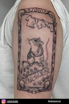 a woman with a tattoo on her arm and the rat is holding an object in it's hand