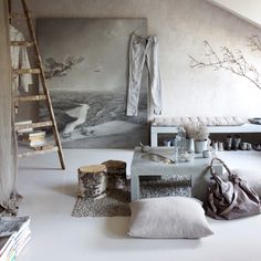 an attic bedroom with white walls and flooring is decorated in neutral colors, including gray