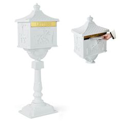 a white mailbox with a person opening it to put letters in the mail box