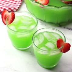 three glasses filled with green liquid and strawberries