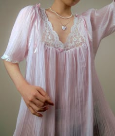 A delicate vintage pastel pink nightgown by designer, Christian Dior - Dainty lace and ribbon detailing along the neckline, sleeves, and hem - Entire gown is constructed from a delicate, pleated, and sheer plisse cotton blend fabric - Era: Circa 1970s - Condition: Excellent - Size: Medium - Color: Pastel pink, white Measurements: - 21.5in pit to pit - 53in garment length - 12.5 sleeve length Fabric Content: - 65% polyester, 35% cotton Shown on a mannequin with a 33" bust, 26" waist, and 35" hips. Fits a size 2-4. Model is 5'5 with a 34A bust. Some garments may be clipped onto mannequin or model for display. Thank you for visiting! Visit my official website, ariessencebyariel.com, for more! Vintage Bustier, Pink Nightgown, Vintage Hollywood Glamour, Vintage Christian Dior, Color Pastel, Women's Nightgowns, Pretty Lingerie, Mode Inspo, Fashion History