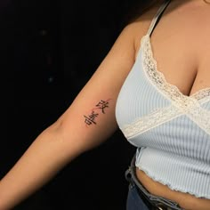 a woman with a cross tattoo on her arm