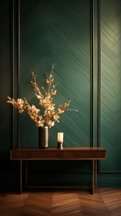 a vase with flowers and candles on a table in front of a green wall that has chevroned wood paneling