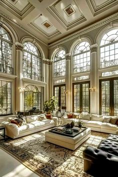 a large living room with high ceilings and lots of windows on the ceiling is filled with furniture