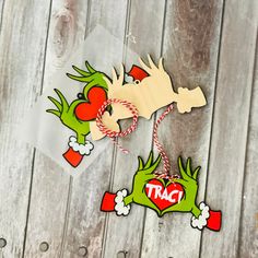 two cut outs with the words tac on them sitting on a wooden table next to some candy canes