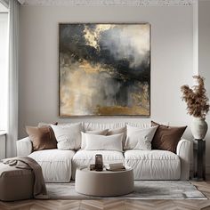 a living room filled with furniture and a large painting on the wall above it's couch