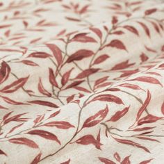 a close up view of a red and white floral print fabric with small leaves on it