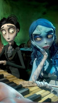 there are two people that are playing the piano and one is dressed as corpsehead