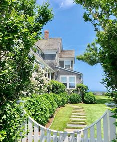 a white picket fence in front of a house