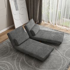 a grey couch sitting on top of a gray rug