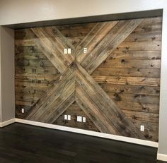 an empty room with wood planks on the wall