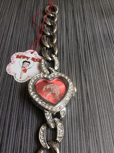 "Betty boop crystal heart with a red heart betty boop dial, all on a silver stainless steel chain bracelet band, ready to be cherished & enjoyed! the item will arrive in a velvet watch pouch, vintange un-used new condition with a new installed battery, working perfectly! measurements: bezel/case 1 3/4 x 1 1/4\", dial 7/8\" x 7/8\", band width 5/8\" and fits a standard 7 1/2\" wrist perfectly. if a smaller perfect fit is needed please contact us, prior to purchasing this item for details needed, Red Betty Boop, Heart Watch, Colorful Outfits, Y2k Accessories, Loc Jewelry, Classy Jewelry, Funky Jewelry, Silver Chain Bracelet, Jewelry Lookbook