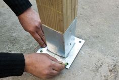 a man is working on a piece of metal that has been placed in the ground