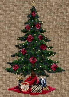 a cross stitch christmas tree with presents under it