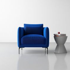 a blue chair sitting next to a small table