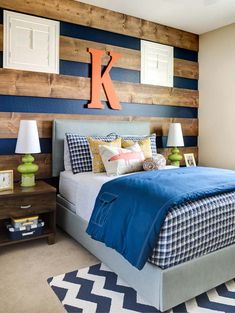 a bedroom decorated in blue and white with wood accenting the walls, bedding and nightstands