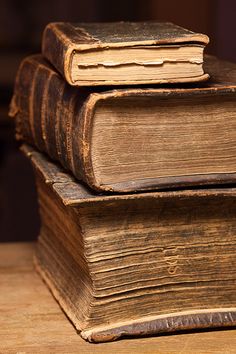 three old books stacked on top of each other