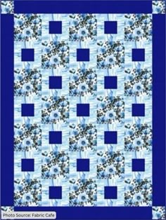 a blue and white quilt with flowers on it