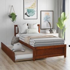 a bed sitting in a bedroom on top of a hard wood floor next to a window