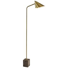 a gold floor lamp with a marble base and a metal cone shade on the top