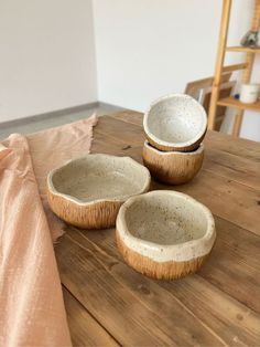 three bowls sitting on top of a wooden table