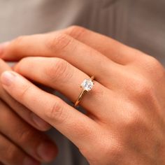 a woman's hand with a diamond ring on it