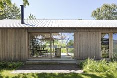 the house is made out of wood and has sliding glass doors to let in natural light