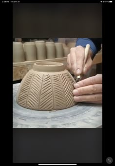 someone is making a vase out of clay