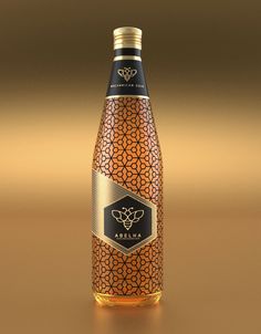 a bottle of wine on a table with a gold and black pattern around the top