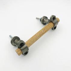 two metal and wood skateboard wheels on a white surface with screws in the middle