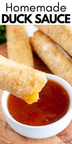 homemade duck sauce in a small white bowl with bread sticks sticking out of the side