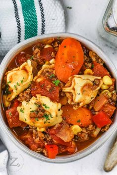 a white bowl filled with pasta and vegetables