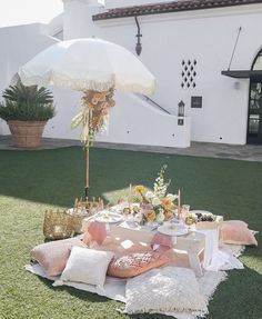 a table set up outside with an umbrella over it