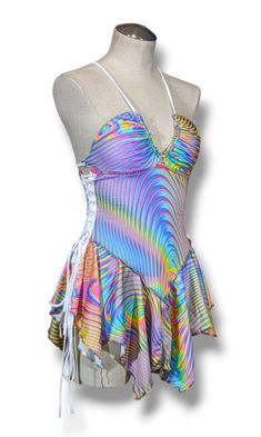 a mannequin wearing a multicolored swimsuit on a white display stand