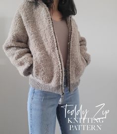 a woman wearing a jacket and jeans is standing in front of a white wall with her hands on her hips