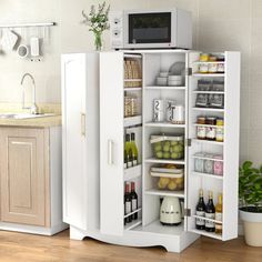 an open refrigerator in a kitchen next to a sink