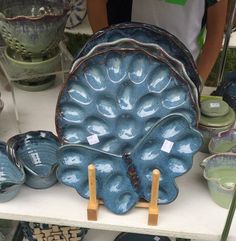 blue dishes and bowls are on display for sale