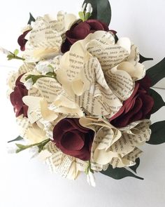 a bridal bouquet made out of book pages and flowers