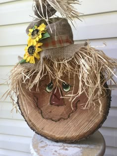 a scarecrow head with sunflowers on it