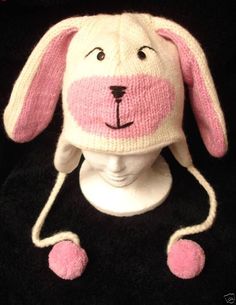 a knitted hat with a pink bunny's face on top of the head