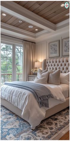 a large bed sitting under a window in a bedroom