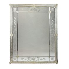 an ornate silver framed mirror on a white background