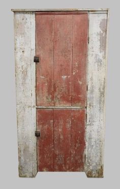 an old wooden door with rusted paint on the front and side panels, painted red