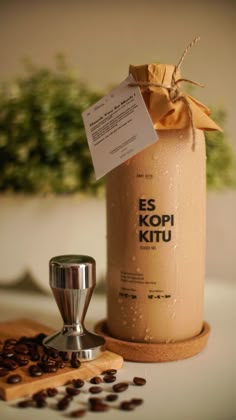 a coffee grinder sitting on top of a counter next to a jar filled with coffee beans