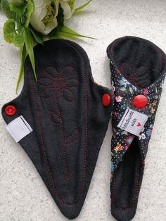 two oven mitts are sitting next to a flower