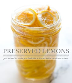 a jar filled with sliced lemons sitting on top of a table