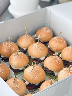 a box filled with mini hamburgers sitting on top of a table