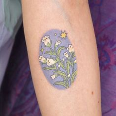 a person with a flower tattoo on their left arm and the other half of her arm