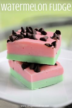 two pieces of watermelon fudge on a white plate with chocolate chips in the middle